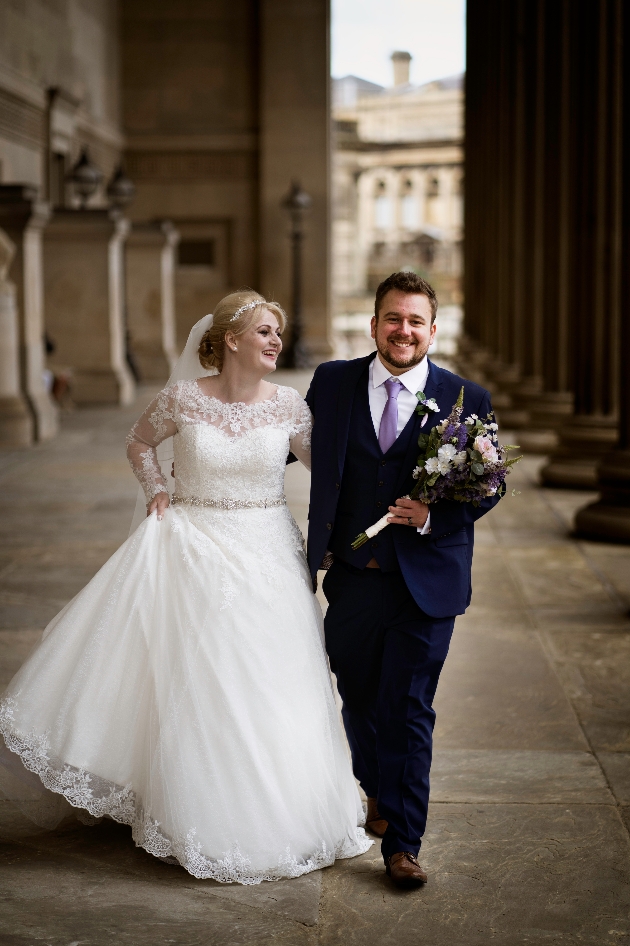 Groom carries bride's bouquet taken by Andy Boyle Photography