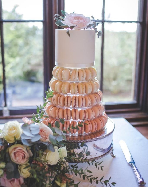 Ombre macaron tower topped with a single layer of cake for cutting by Boutique Bakery in Chester