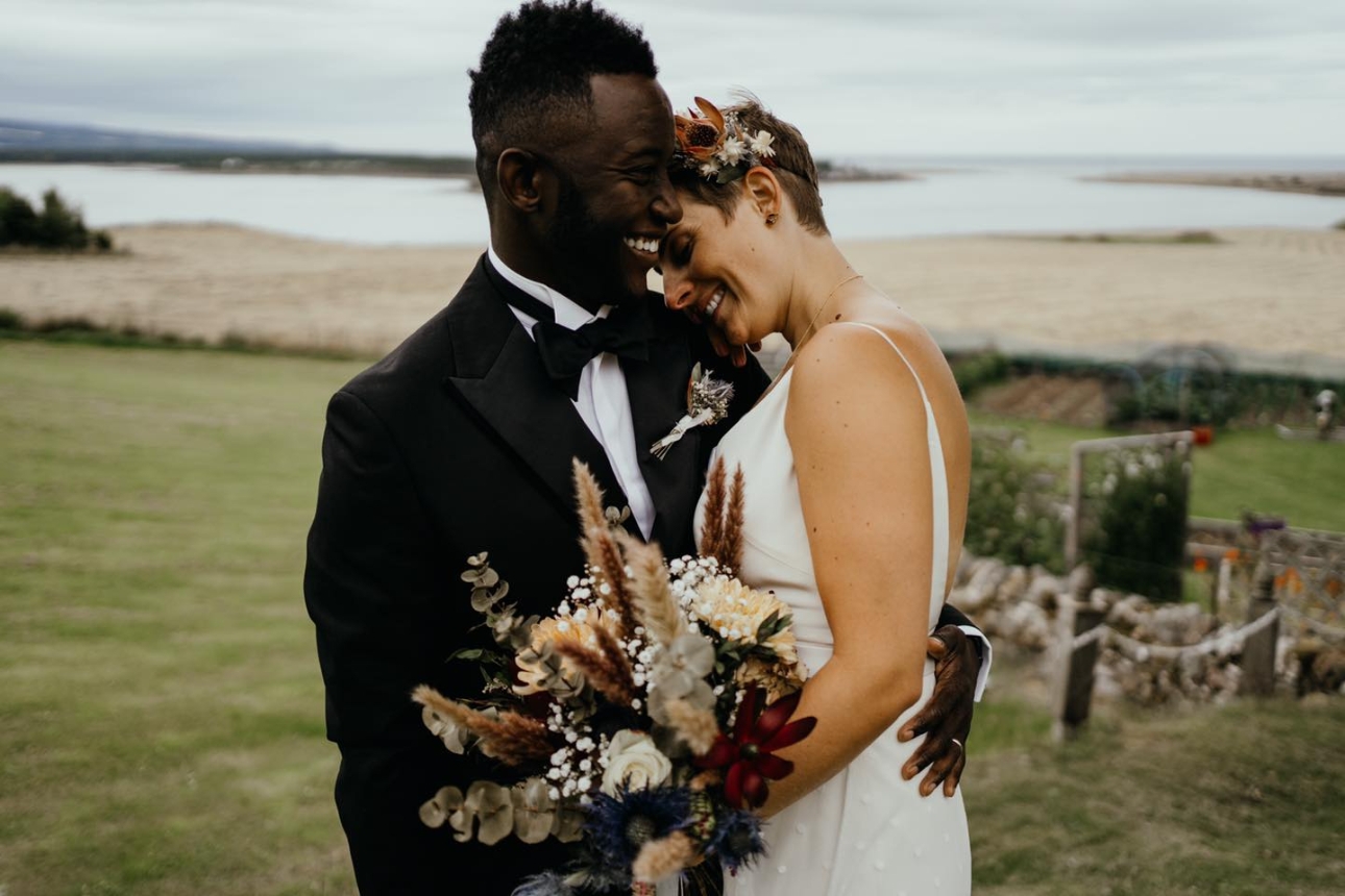 bride and groom on their wedding day on cliff top