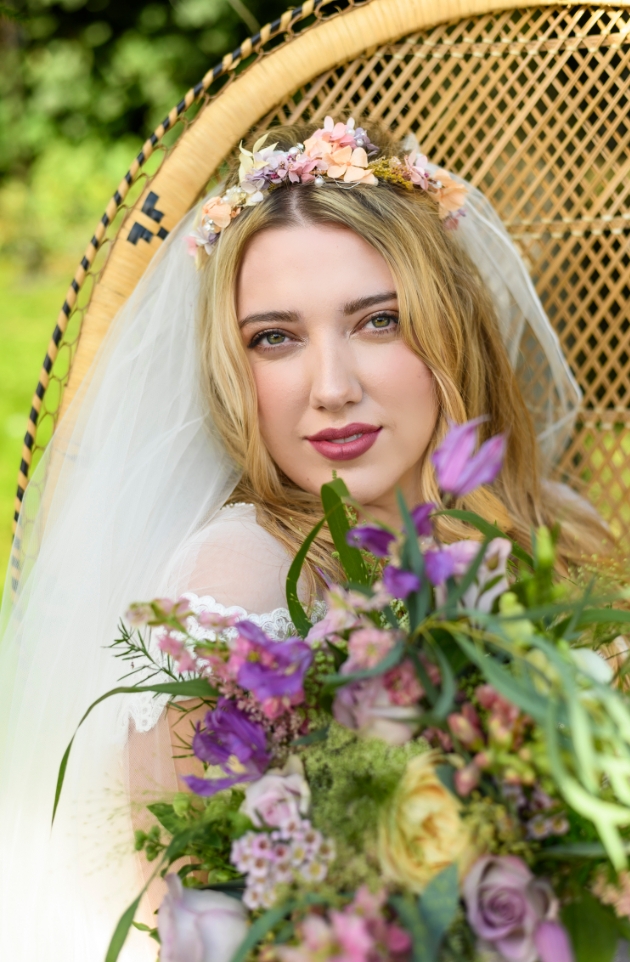 bride outside sitting on wicker chair wearing flower crown