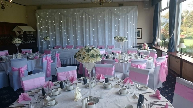 Wedding reception layout at Haydock Park Golf Club with fairylight backdrop