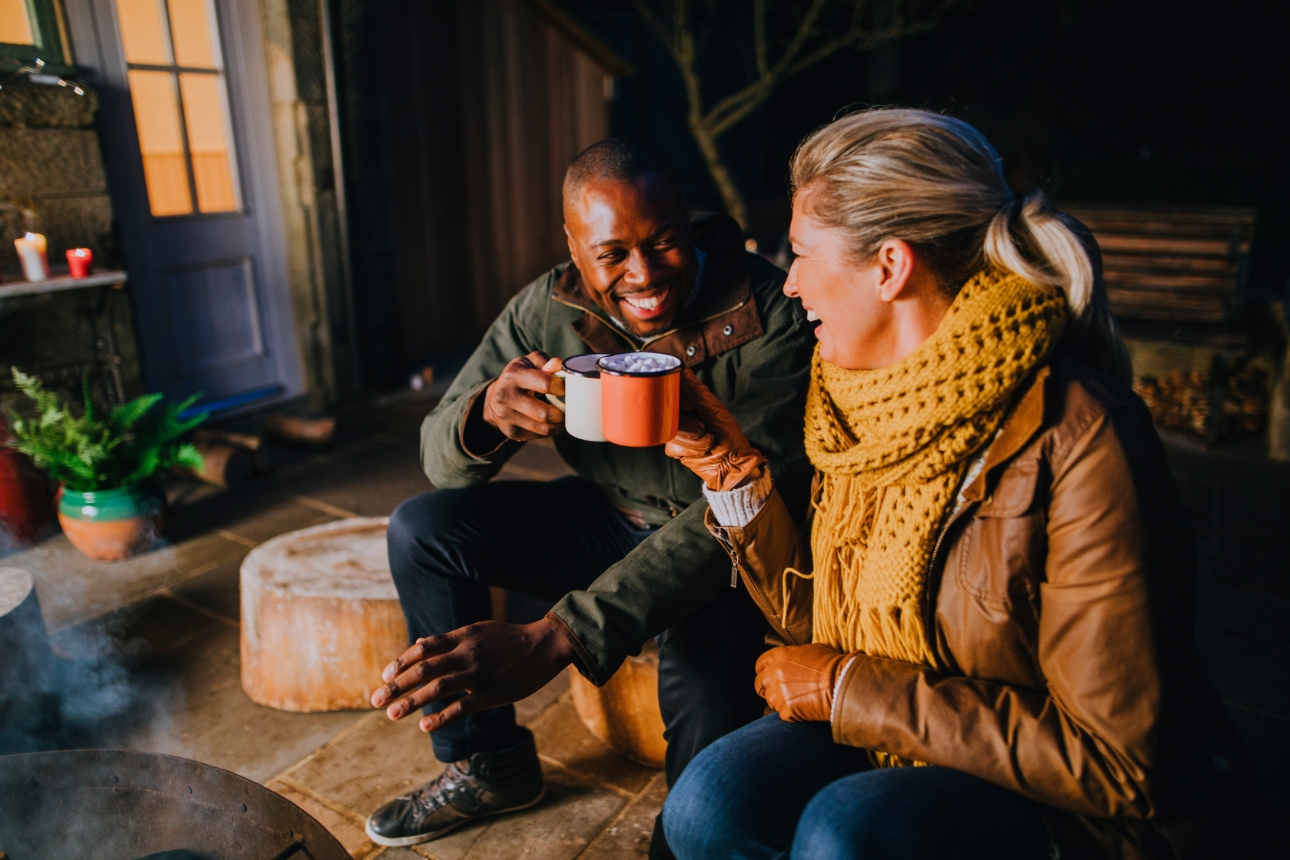 couple at night around a fire pit in backgarden