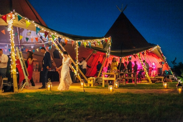 Colourful tipi wedding celebrations at nighttime