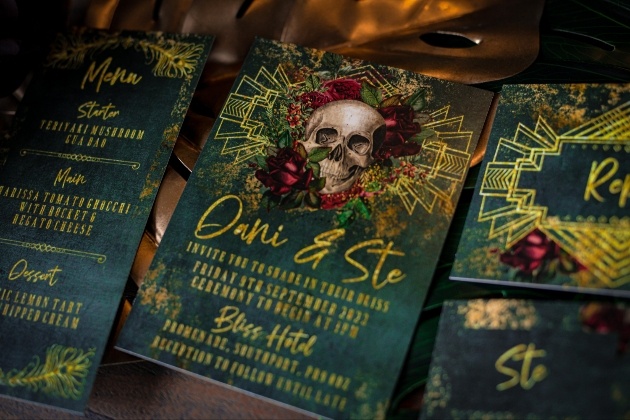 Emerald green and gold wedding stationery with skull motif