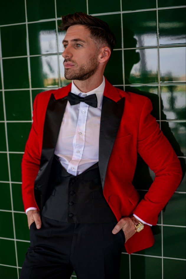 groom wearing a red dinner jacket with black lapels