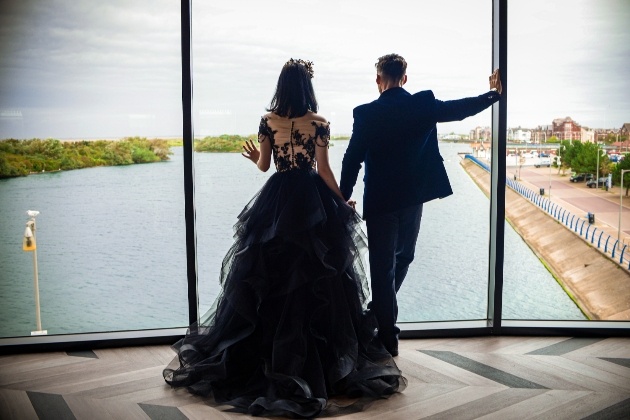 Bride and groom dressed in black admiring views of Southport