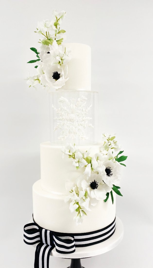 white 4 tier black and white cake with invisible layer