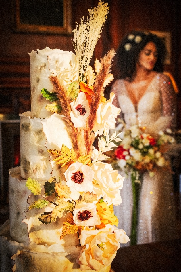 wedding cake with bride in the background