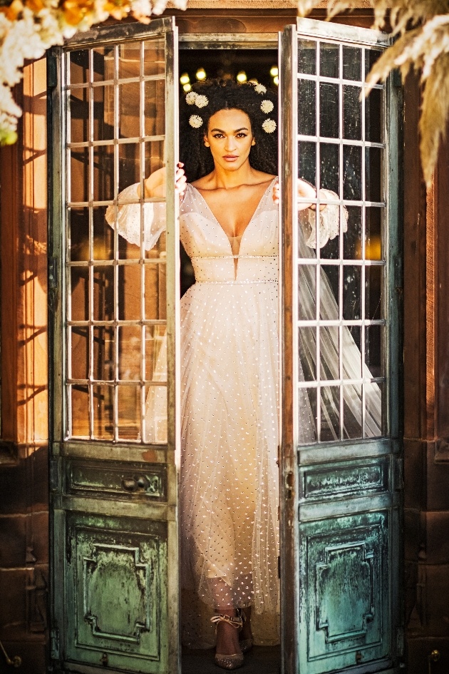 bride makes her entrance through french doors.