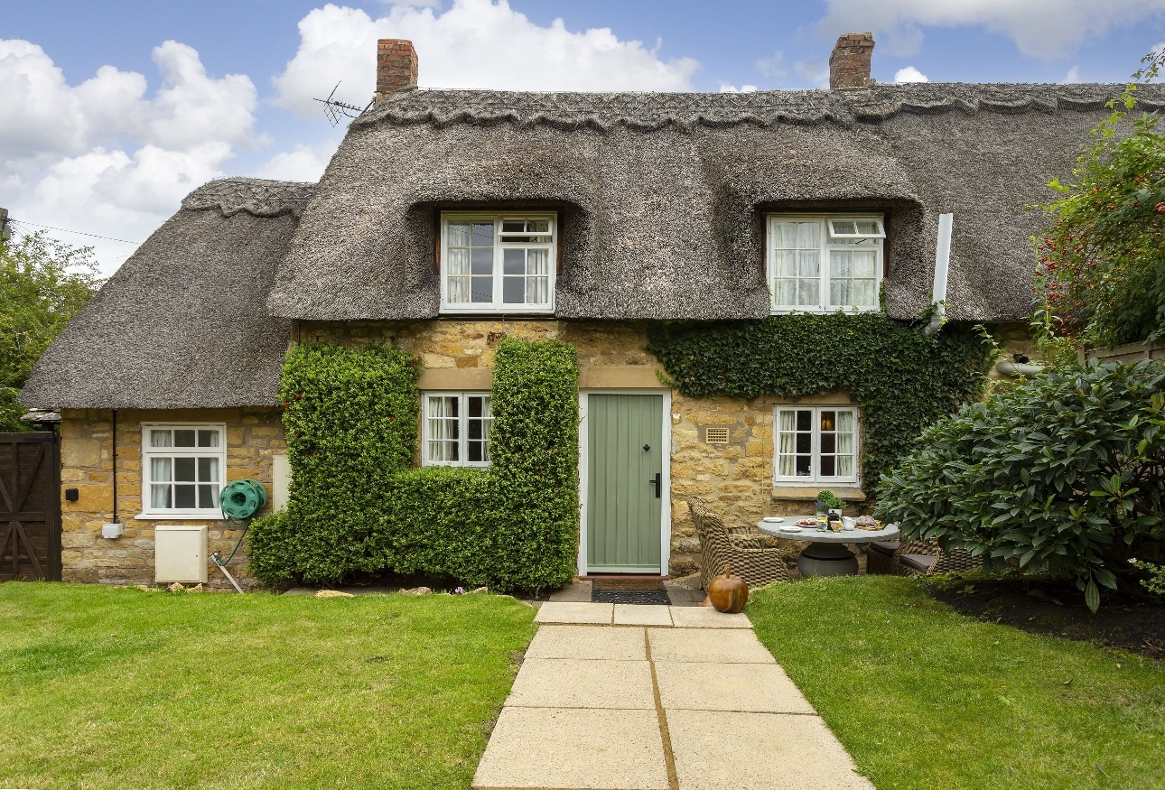 cottage with thatched roof green door