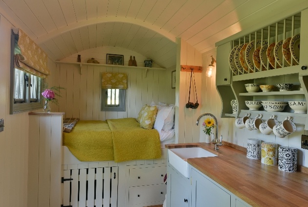 cabin bed white wood interior kitchen area