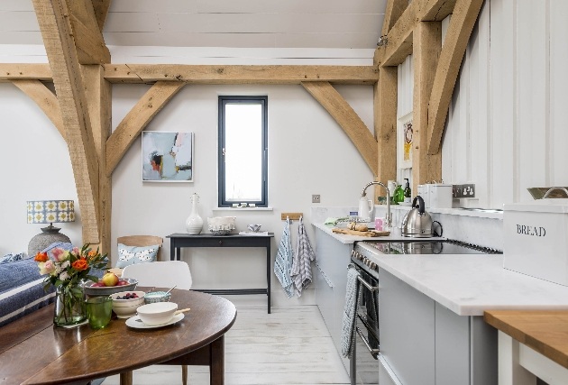 open plan kitchen with wooden ceiling beams on view