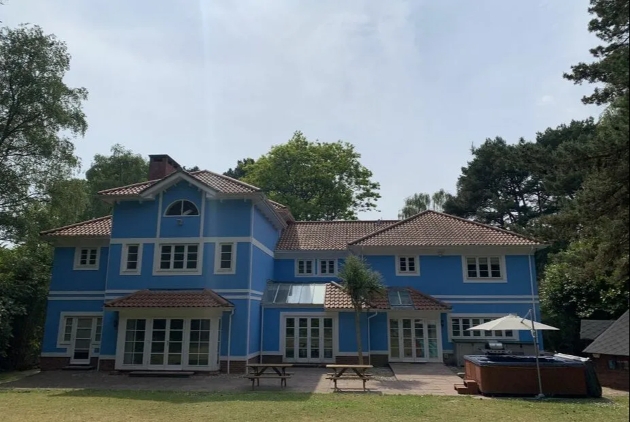 blue wooden villa with hot tub