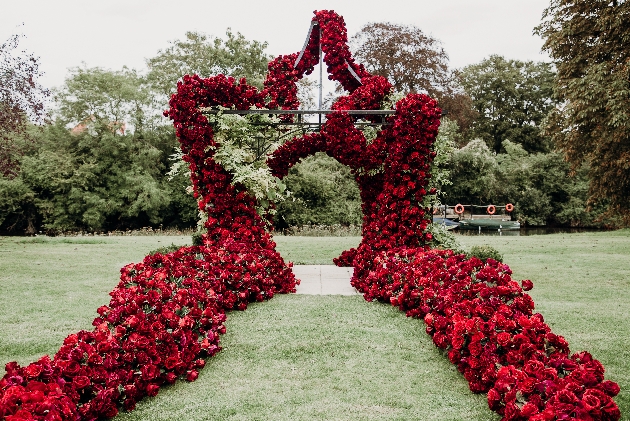 large luxurious red rose floral decoration around outside gazebo