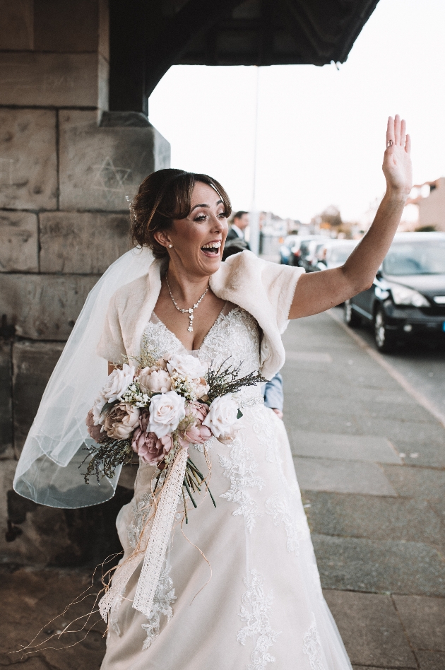 Happy bride waving