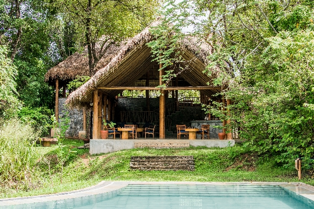 al fresco hut restaurant with pool in front in the forest