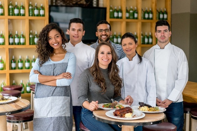 chef and couple trying food in a restaurant 