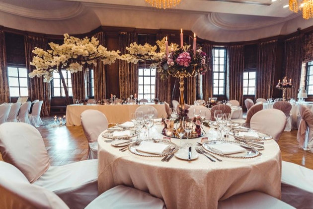 wedding reception room with tables laid out for a wedding breakfast