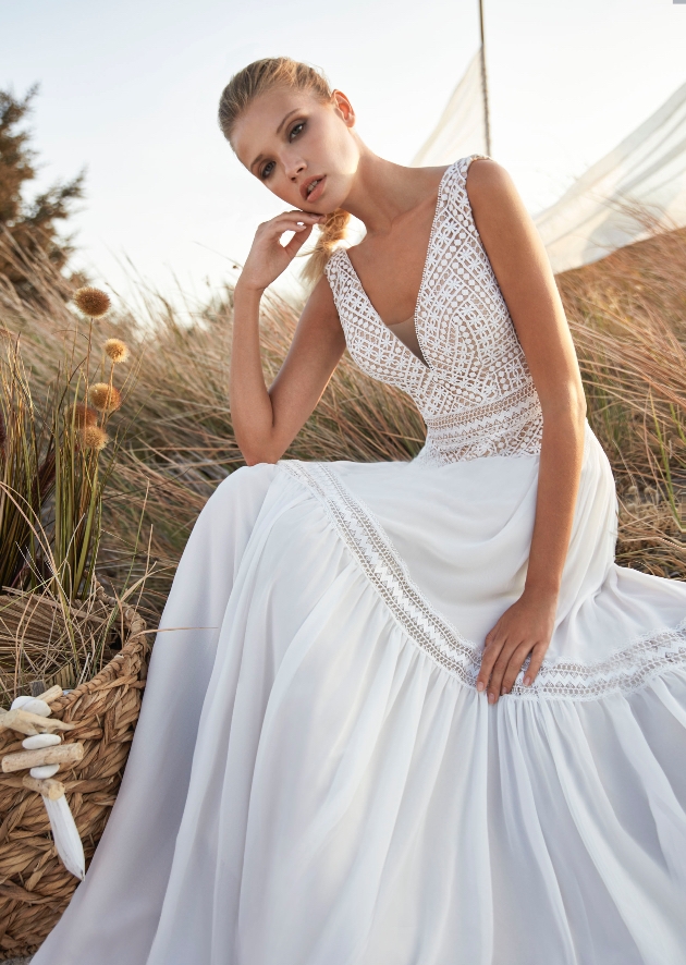 Model wearing lace gown with illusion neckline