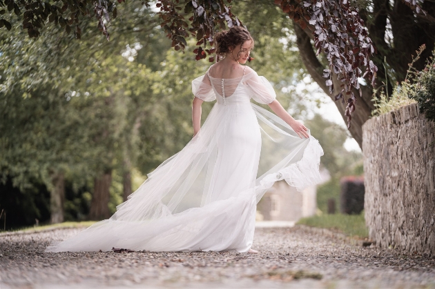 Back view of bride in wedding dress with light tulle layer and puff sleeves