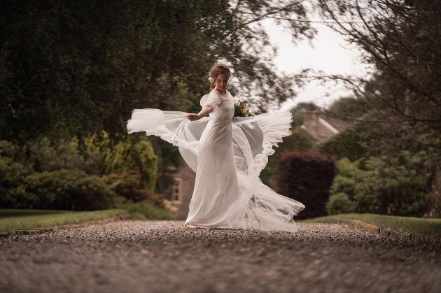 Bride swishing around in a wedding dress with light tulle layer