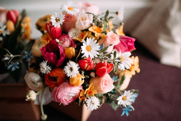 Springtime wedding bouquet in yellow, pink, white and blue