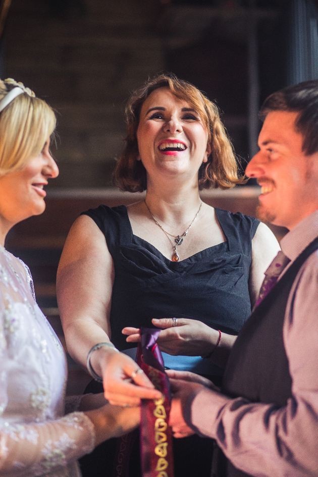 Celebrant Sarah Nelson performing and handfasting ceremony