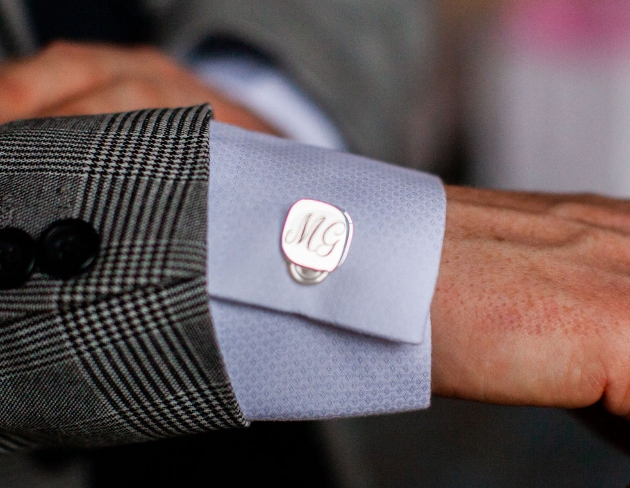 Close up of wedding cufflink monogrammed MG