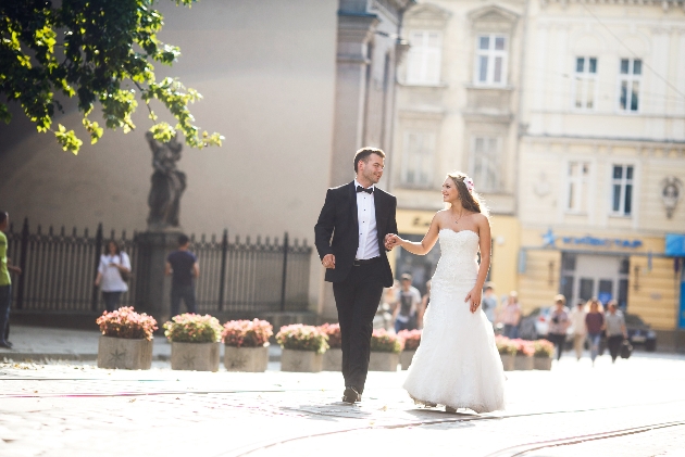 bride and groom hand in hand walking round the streets of london