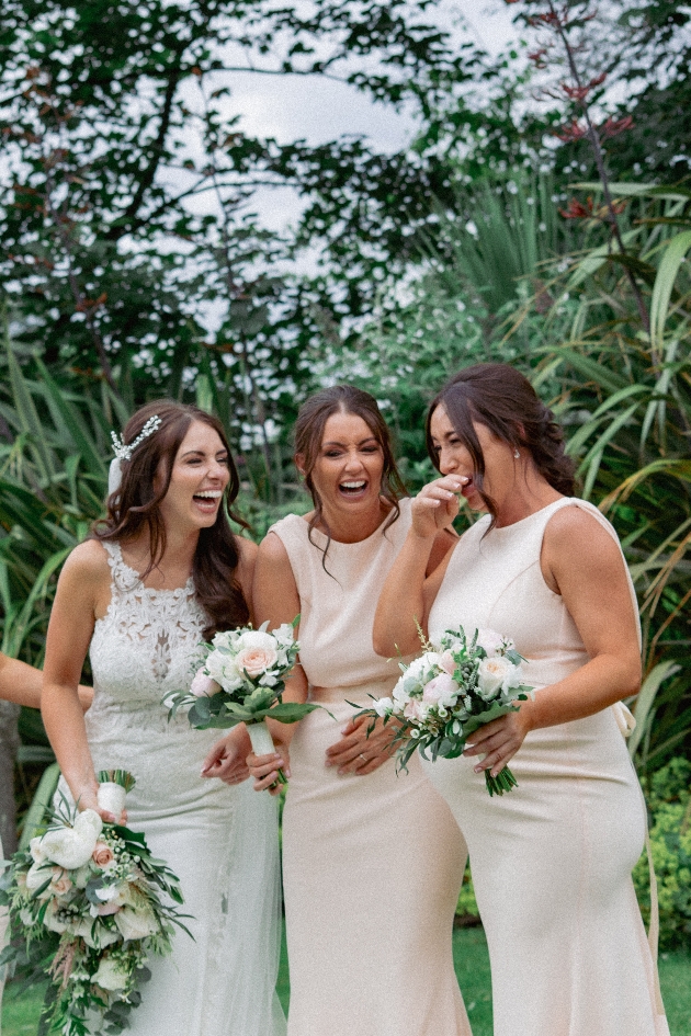 Bride laughing with bridesmaids