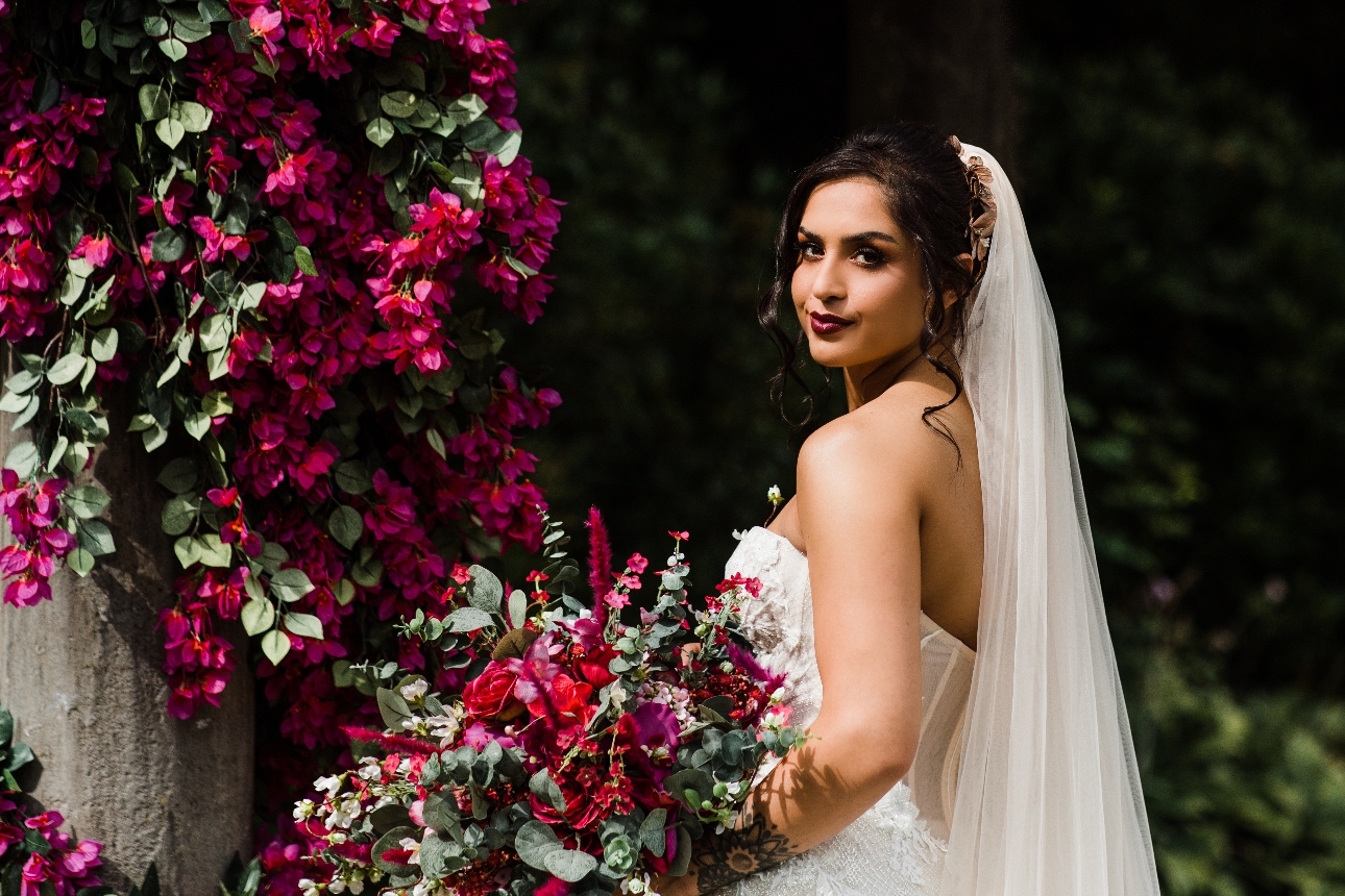 Bride holding a fucschia coloured bouquet