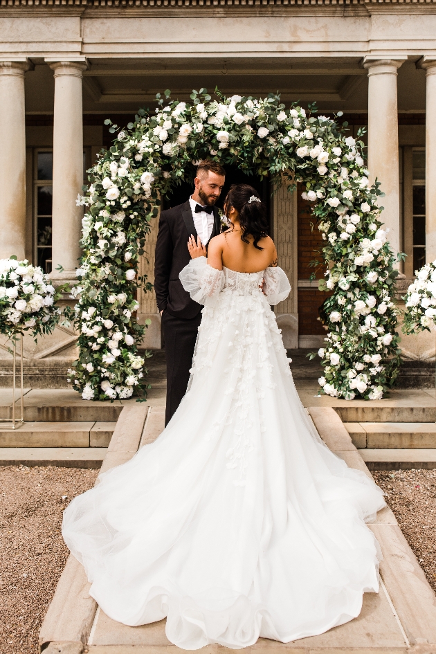 Bride and groom white floral arch by Thornton Events