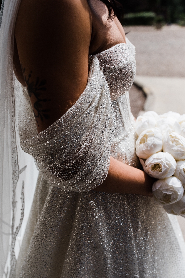 Glittery wedding dress with off the shoulder sleeves