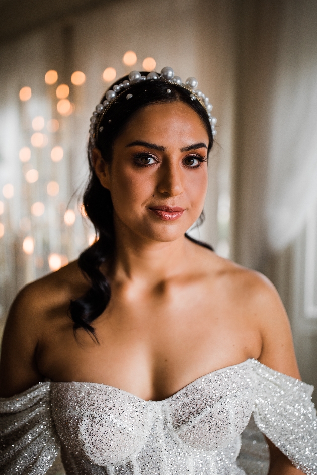Bride with pearl head band and off the shoulder glittery dress