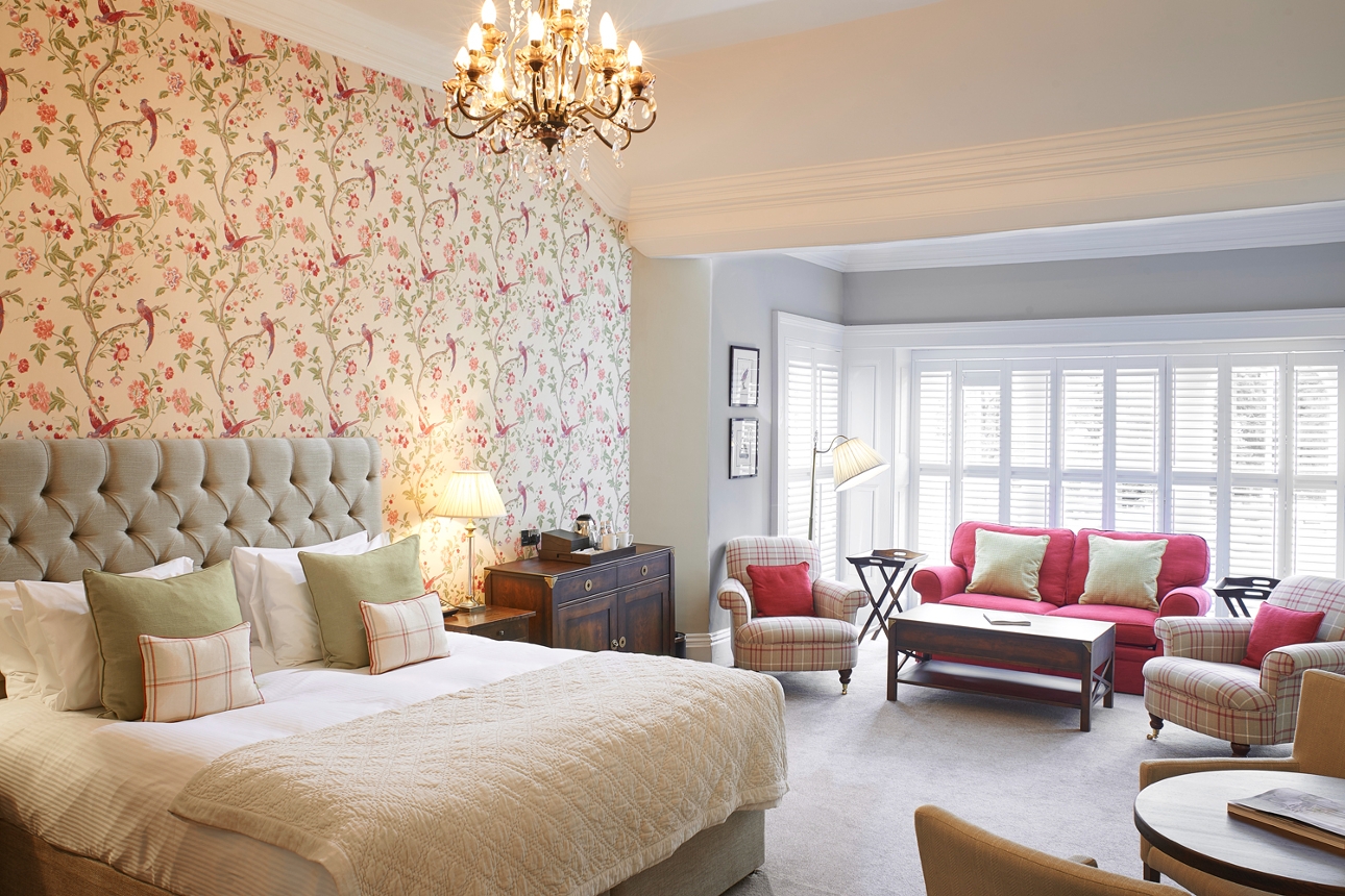 large suite with laura ashley wallpaper and furnishings in cream and red