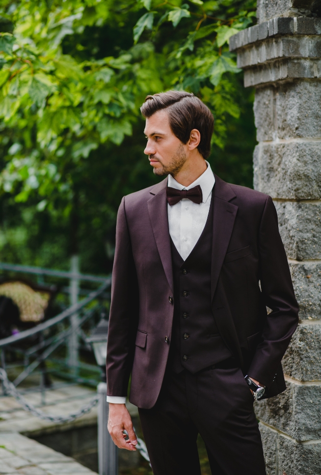 dark haired male model in a deep red suit