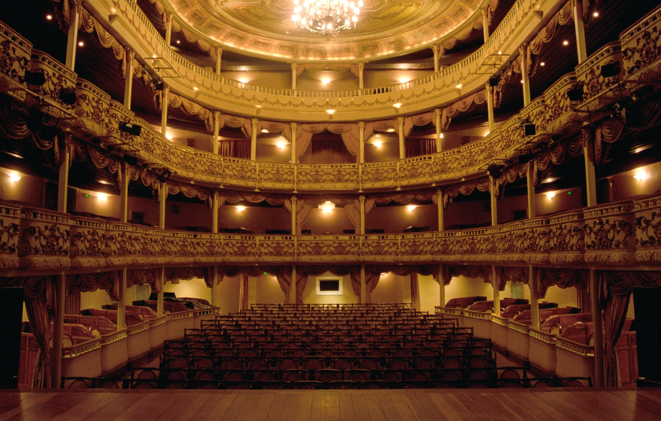 empty theatre stage view looking out to seats