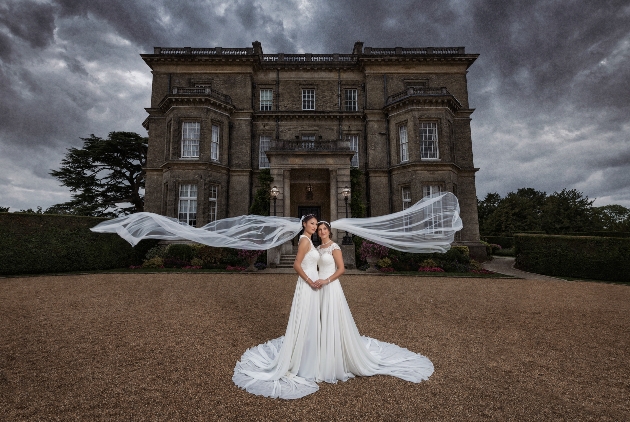 two brides outside historic house