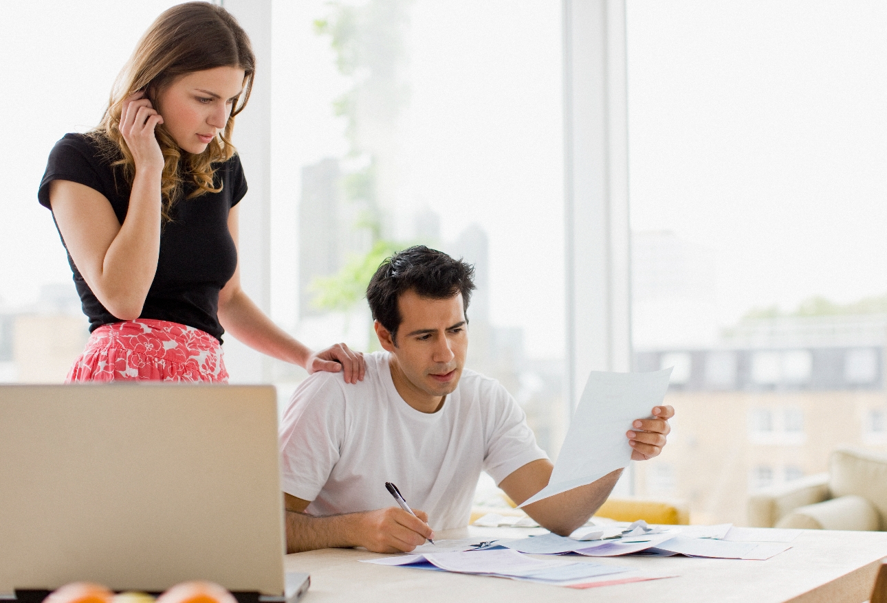 couple looking at finances at a table