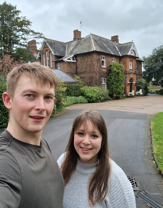 couple taking selfie in front of hotel