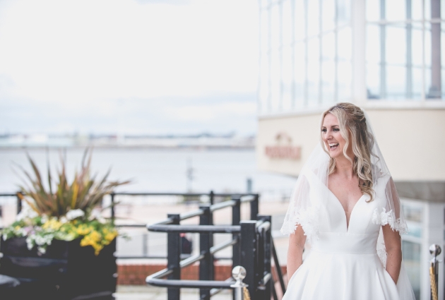 Exterior of waterfront venue Floral Pavilon featuring a bride