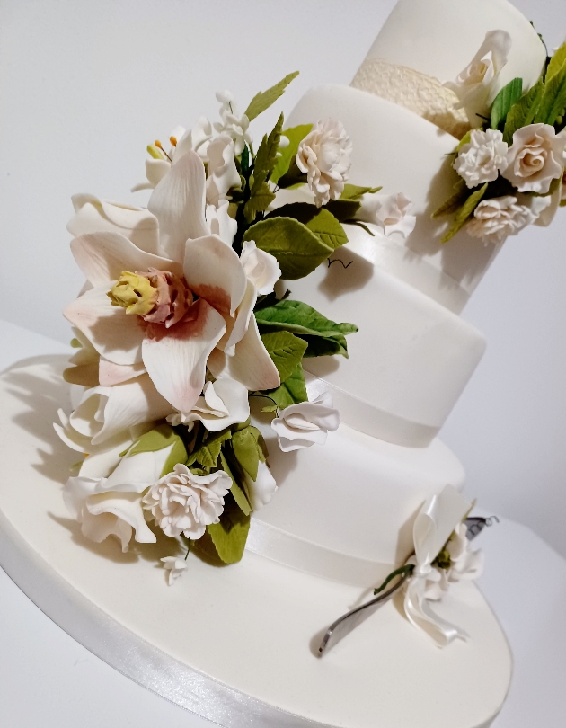 Wedding cake by Cake on The Lake with white sugar flower decoration