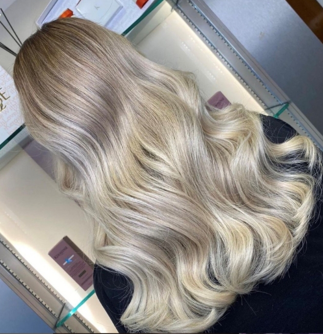 Silver blonde long wavvy hair seen from the back