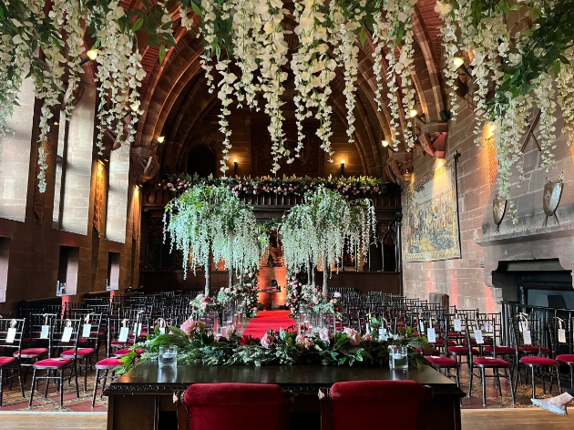 maximalist wedding ceremony set up at Peckorton Castle wisteria