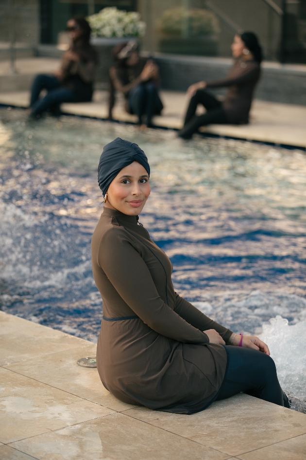 Lady sitting on the edge of the pool wearing LYRA Swim