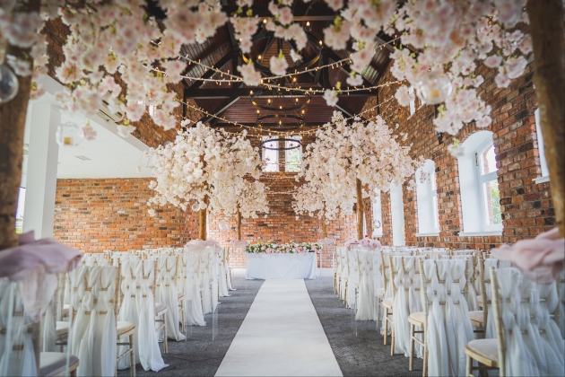 ceremony space at Doubletree Hilton Chester with chair sashes and hanging floral features