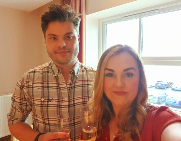 couple in hotel room taking selfie