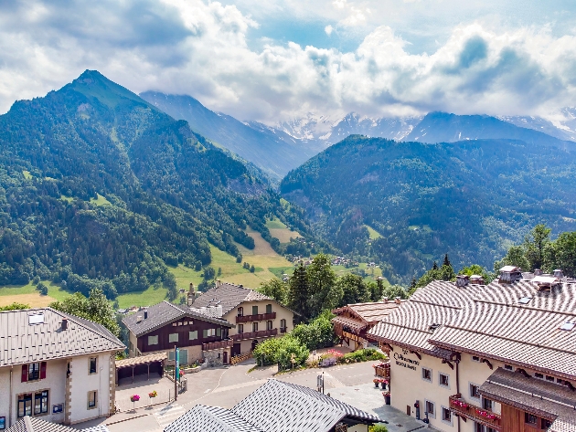 Several buildings nestled within a mountain range