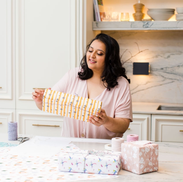 woman holding presents in a kitchen