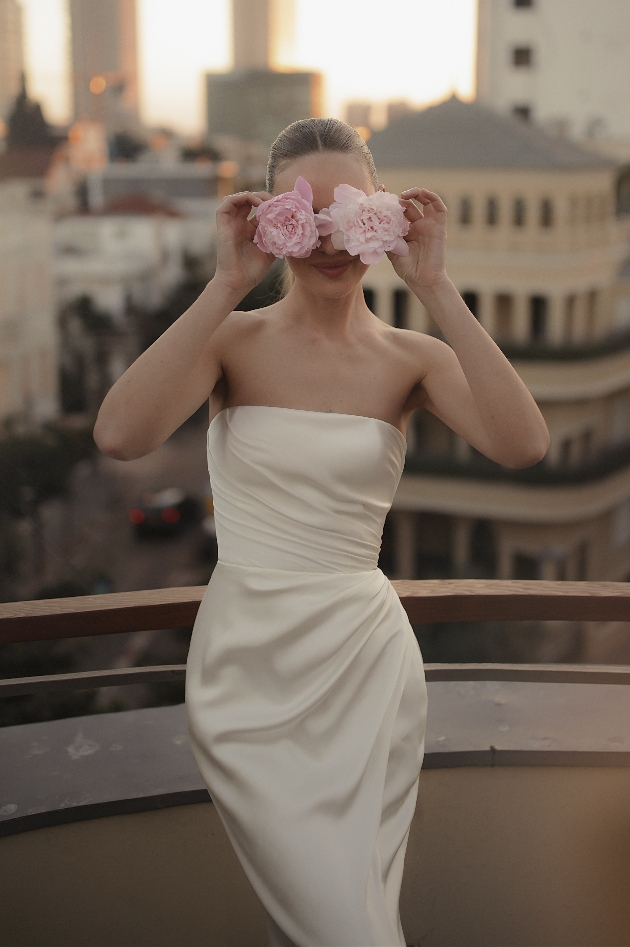 model in strapless corset dress with gathered overlay pleats